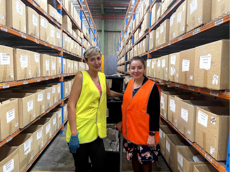 Two workers a the OzSale distribution centre in Smithfield, NSW