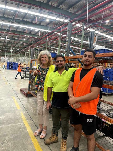 Three workers a the OzSale distribution centre in Smithfield, NSW