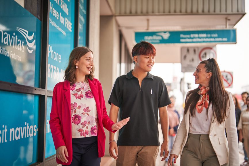 Sanja Nikolic walking outside the Navitas Skilled Futures college with two colleagues