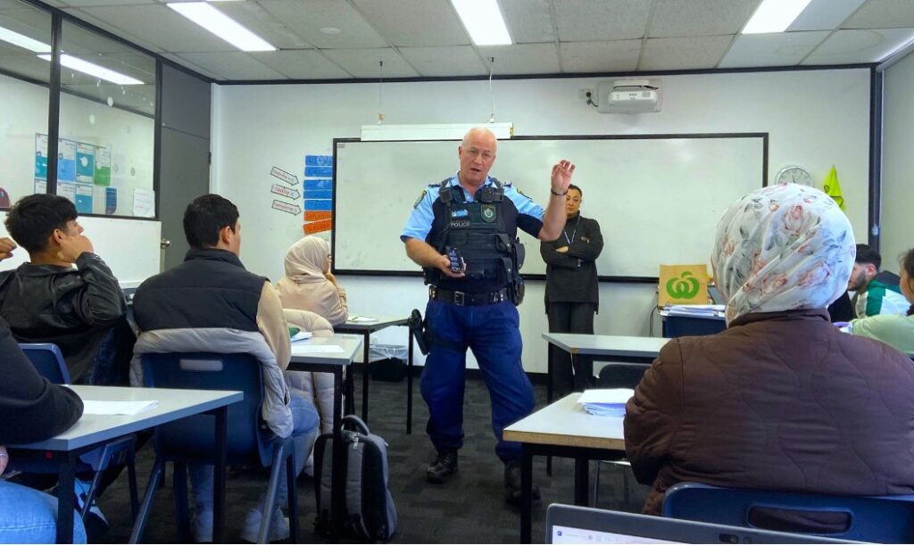 A policeman giving a presentation in a classroom at NSF Fairfield college