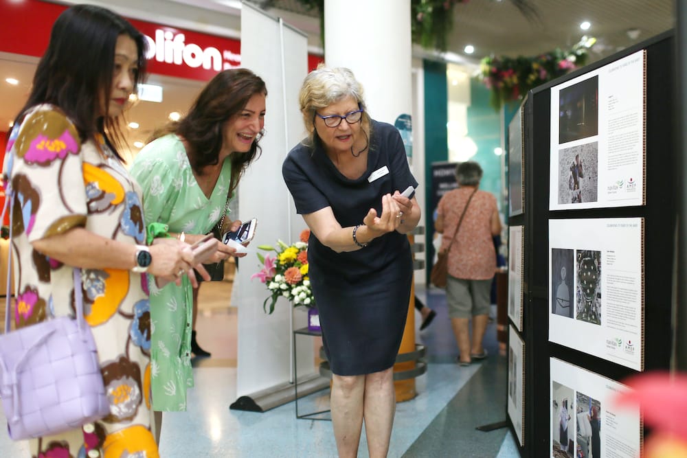 Staff and students looking at photo exhbition